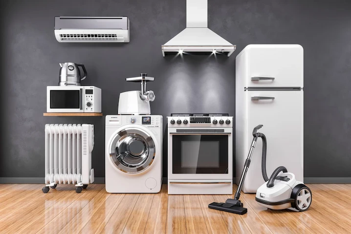 Modern home appliances including refrigerator, washing machine, stove, and vacuum